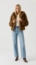 Brown faux fur hooded jacket for women, cropped and worn open with a cream top and wide-leg jeans, ELLA Toronto