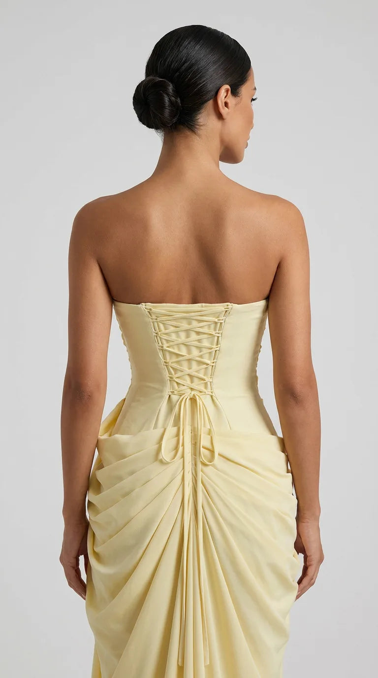 Close-up of the back of the Delphine Draped Maxi Dress – Light Yellow, showing the lace-up corset back and fit, ELLA Toronto