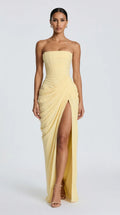 Light yellow strapless draped maxi dress with lace-up corset back for women, front view of the Delphine Draped Maxi Dress – Light Yellow by ELLA Toronto in a light grey studio