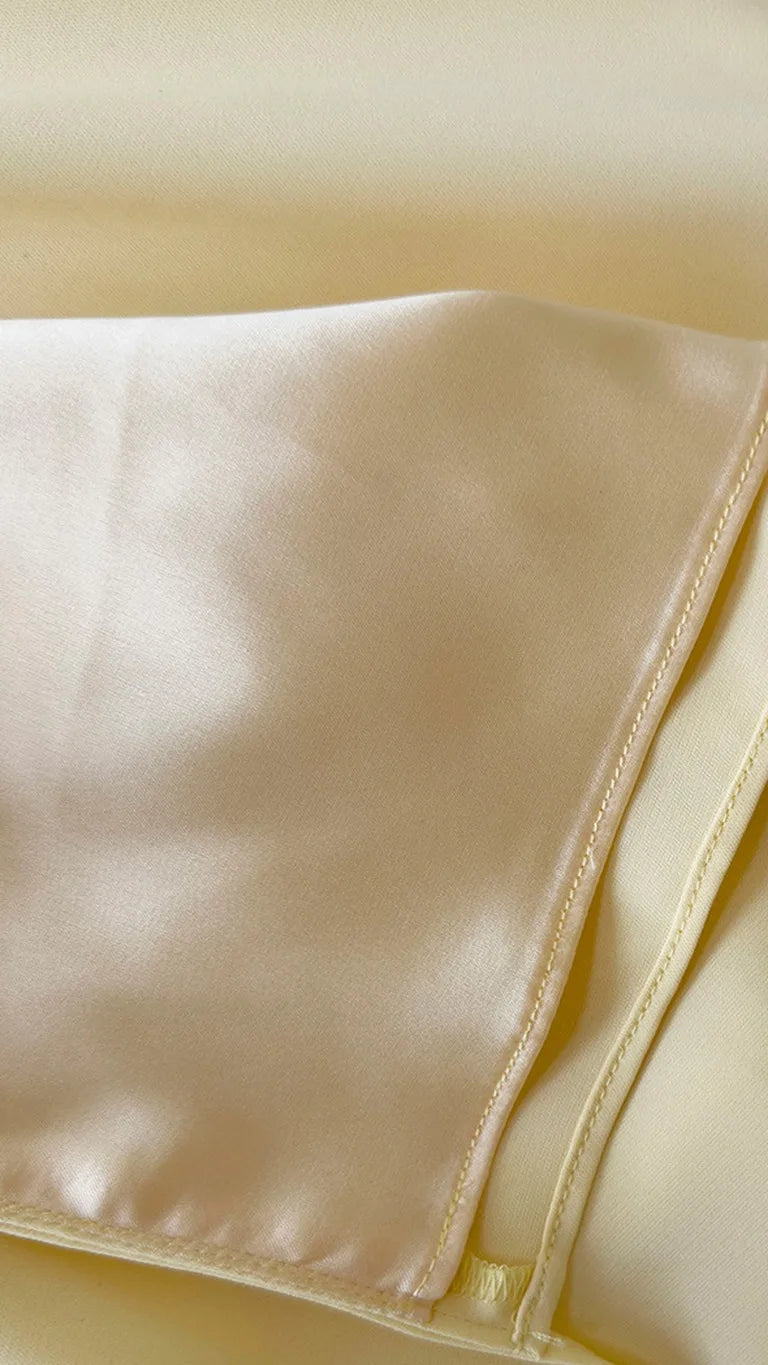 Inside of the Delphine Draped Maxi Dress – Light Yellow held open to show the lining, ELLA Toronto