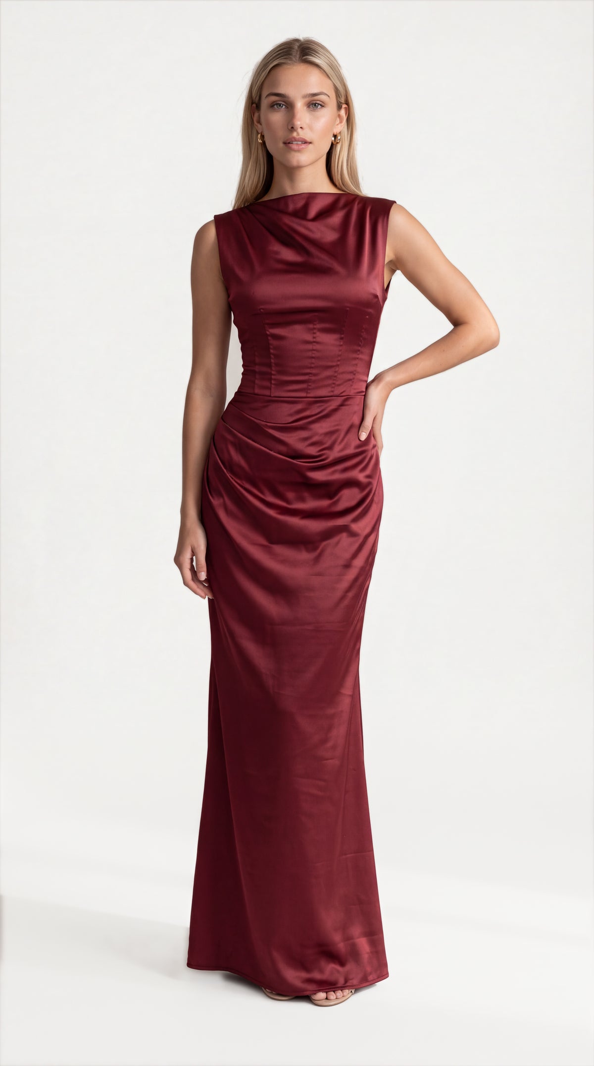 Burgundy satin corset maxi dress with draped neckline for women, front view of the Genevieve Satin Corset Maxi Dress – Burgundy by ELLA Toronto in a light grey studio