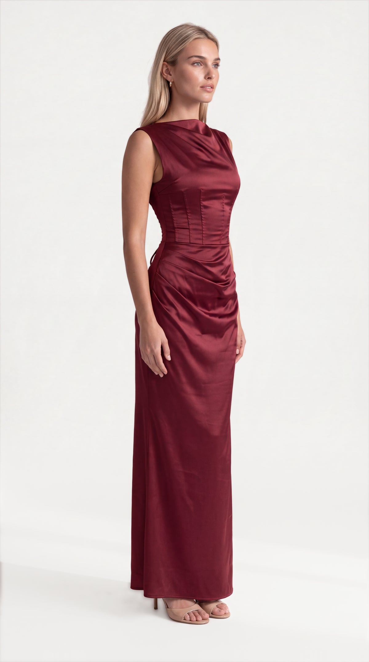 Burgundy satin corset maxi dress with draped neckline for women, side view of the Genevieve Satin Corset Maxi Dress – Burgundy showing the relaxed fit and length, ELLA Toronto