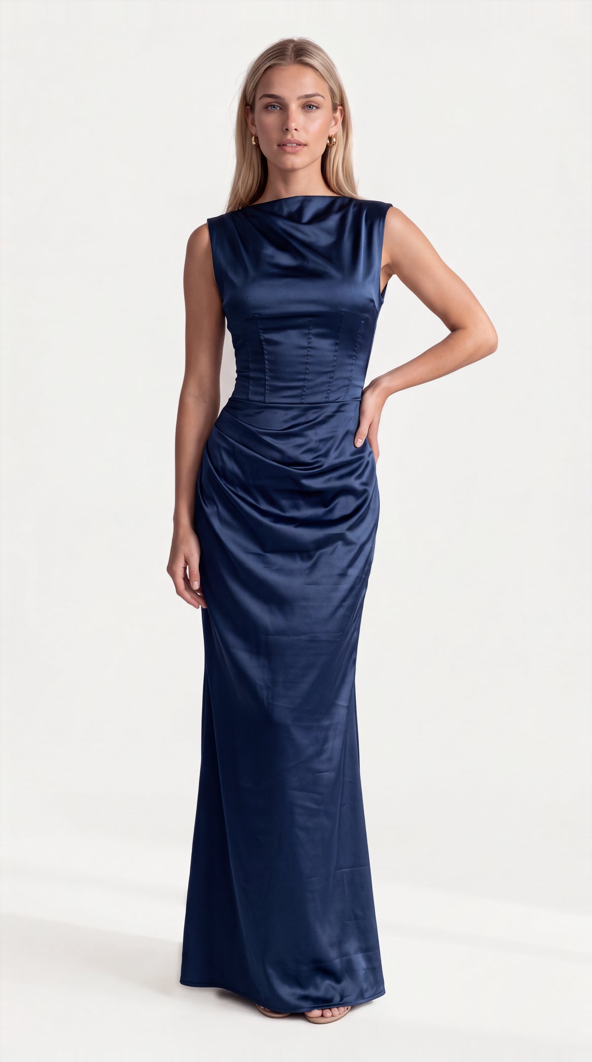 Navy blue satin corset maxi dress with draped neckline for women, front view of the Genevieve Satin Corset Maxi Dress – Navy Blue by ELLA Toronto in a light grey studio