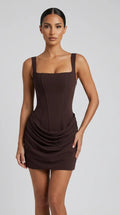 Chocolate brown corset mini dress with lace-up back and draped hip skirt for women, the Margaux Corset Mini Dress – Chocolate Brown by ELLA Toronto, front view from head to knee showing the neckline, bodice and fit