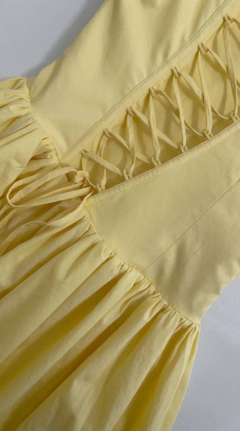 Close-up of the Odette Bubble Midi Dress – Cream Yellow showing the bubble hem and ruched front slit, ELLA Toronto