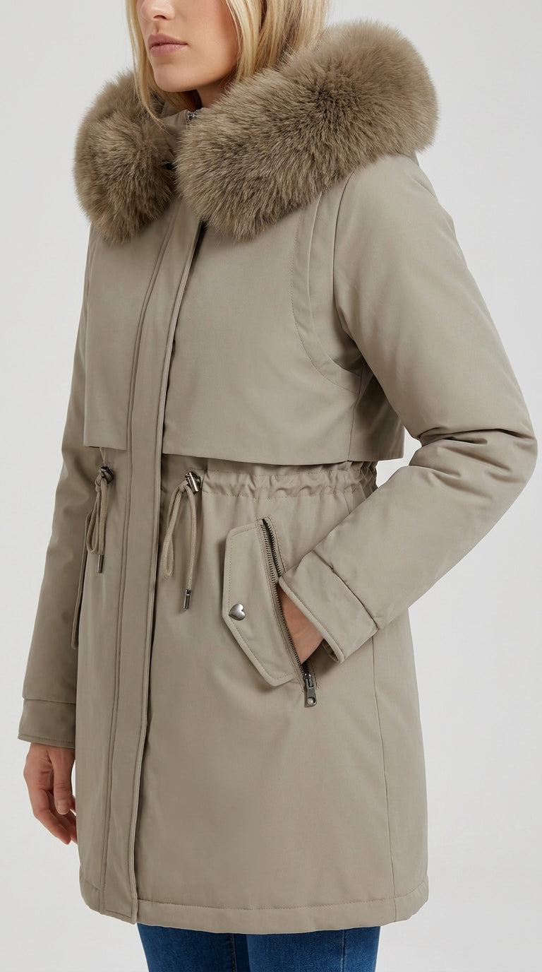 Close-up of the faux fur hood, drawstring waist and heart snap pocket on the khaki Rosedale long parka